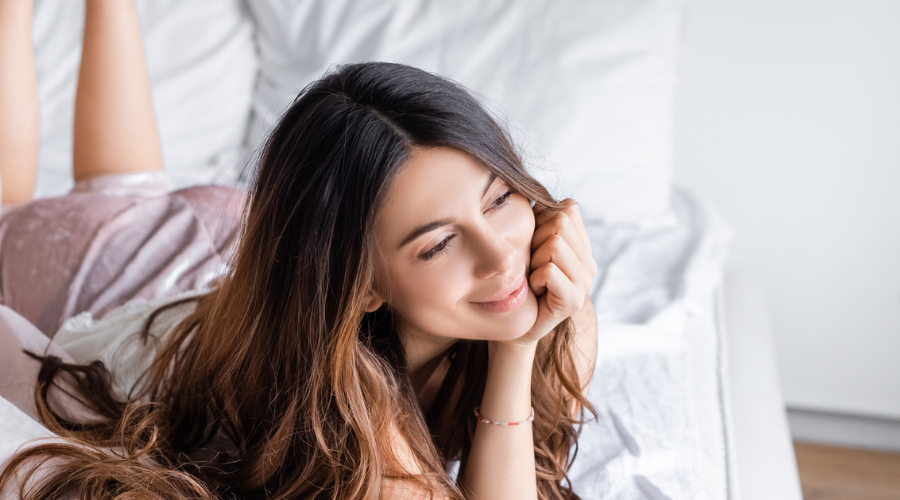 Happy woman thinking about 45 Daily Powerful Positive Affirmations About Beauty